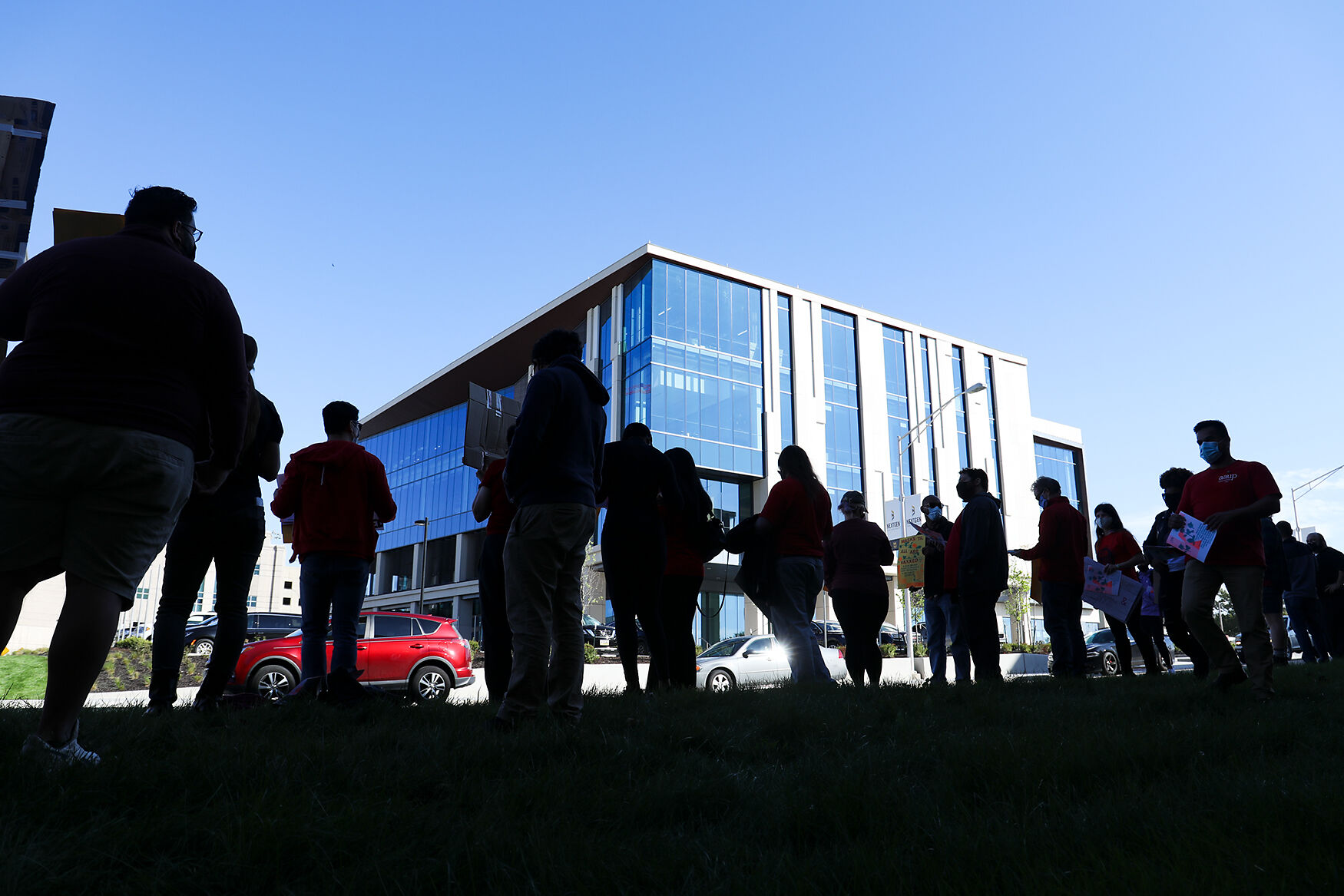 Protesters face the Roy Blunt NextGen Precision Health Building during a protest